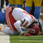Sep 29, 2024; Inglewood, California, USA; Kansas City Chiefs wide receiver Rashee Rice (4) pounds his fist on the ground after an injury in the first half against the Los Angeles Chargers at SoFi Stadium. Mandatory Credit: Jayne Kamin-Oncea-Imagn Images