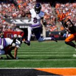 Baltimore Ravens quarterback Lamar Jackson (8) leaps away from Cincinnati Bengals defensive end Sam Hubbard (94) on a keeper in the first quarter of the NFL Week 5 game between the Cincinnati Bengals and Baltimore Ravens at Paycor Stadium in downtown Cincinnati on Sunday, Oct. 6, 2024. The Bengals led 17-14 at halftime.