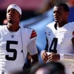 Oct 6, 2024; Landover, Maryland, USA; Cleveland Browns quarterback Deshaun Watson (4) and quarterback Jameis Winston (5) stand on the sideline during the fourth quarter of the game against the Washington Commanders at NorthWest Stadium. Mandatory Credit: Peter Casey-Imagn Images