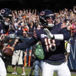 Oct 6, 2024; Chicago, Illinois, USA; Chicago Bears quarterback Caleb Williams (18) runs for a touchdown that was called back because of a penalty against the Carolina Panthers during the second half at Soldier Field.