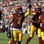 Oct 6, 2024; Landover, Maryland, USA; Washington Commanders linebacker Frankie Luvu (4) celebrates with teammates after recovering a fumble against the Cleveland Browns during the third quarter at NorthWest Stadium.