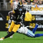 Oct 6, 2024; Pittsburgh, Pennsylvania, USA; Pittsburgh Steelers wide receiver George Pickens (14) breaks a tackle by Dallas Cowboys cornerback Jourdan Lewis (2) during the first quarter at Acrisure Stadium. Mandatory Credit: Barry Reeger-Imagn Images