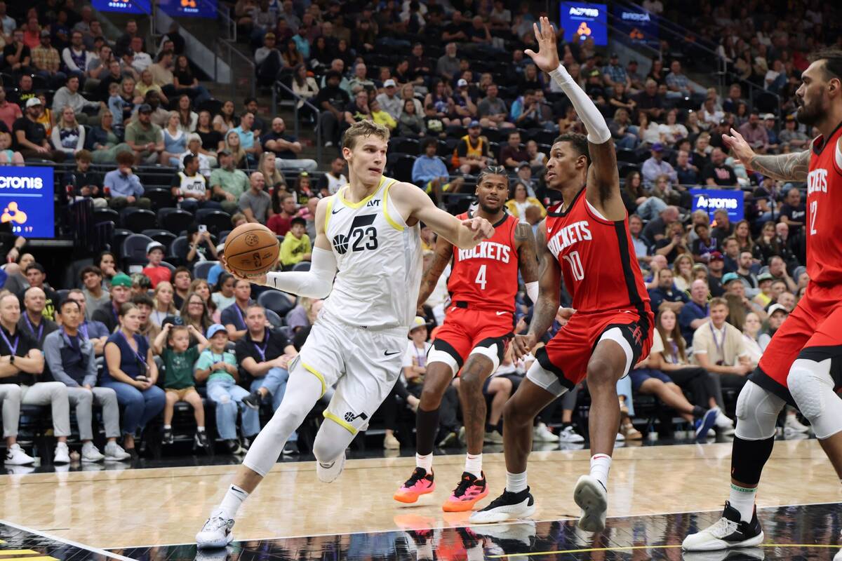 Oct 7, 2024; Salt Lake City, Utah, USA; Utah Jazz forward Lauri Markkanen (23) drives against Houston Rockets forward Jabari Smith Jr. (10) during the second quarter at Delta Center. Mandatory Credit: Rob Gray-Imagn Images