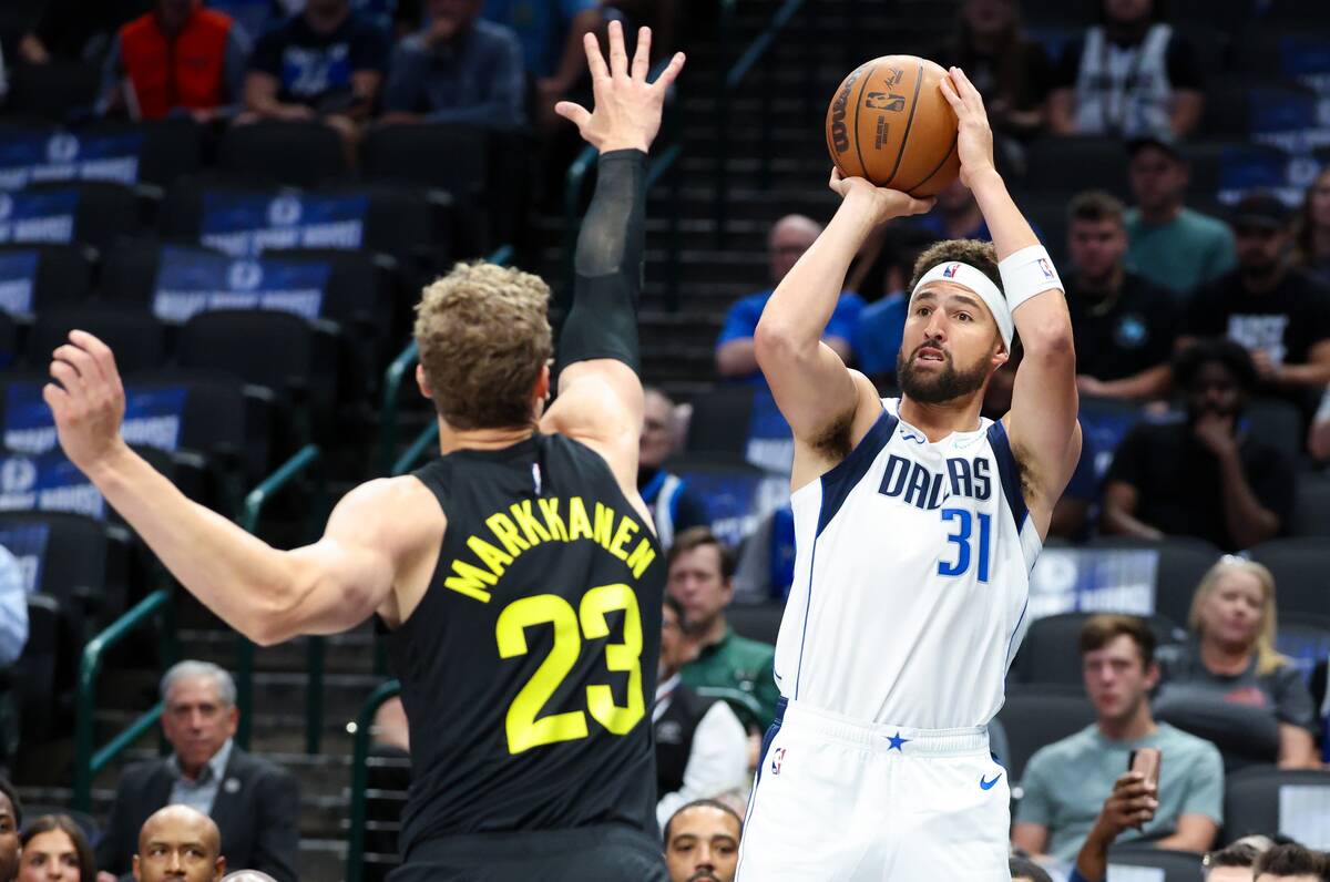 Oct 10, 2024; Dallas, Texas, USA; Dallas Mavericks guard Klay Thompson (31) shoots over Utah Jazz forward Lauri Markkanen (23) during the first quarter at American Airlines Center.