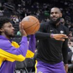 Oct 10, 2024; Milwaukee, Wisconsin, USA; Los Angeles Lakers forward LeBron James (23) goofs around with his son guard Bronny James (9) during warm ups before their game against the Milwaukee Bucks at Fiserv Forum.