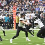 Oct 13, 2024; London, United Kingdom; Jacksonville Jaguars quarterback Trevor Lawrence (16) passes to Jacksonville Jaguars running back Travis Etienne Jr. (1) during the first half of an NFL International Series game at Tottenham Hotspur Stadium. Mandatory Credit: Peter van den Berg-Imagn Images