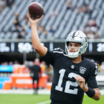 Oct 13, 2024; Paradise, Nevada, USA; Las Vegas Raiders quarterback Aidan O'Connell (12) warms up before a game against the Las Vegas Raiders at Allegiant Stadium.
