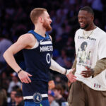 Oct 13, 2024; New York, New York, USA; Minnesota Timberwolves guard Donte DiVincenzo (0) celebrates with forward Julius Randle (30) during the first half against the New York Knicks at Madison Square Garden.