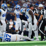 NFL: Detroit Lions at Dallas Cowboys. Oct 13, 2024; Arlington, Texas, USA; Detroit Lions defensive end Aidan Hutchinson (97) injures himself while trying to tackle Dallas Cowboys quarterback Dak Prescott (not pictured) during the second half at AT&T Stadium. Mandatory Credit: Kevin Jairaj-Imagn Images