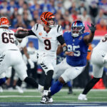 NFL: Cincinnati Bengals at New York Giants. Oct 13, 2024; East Rutherford, New Jersey, USA; Cincinnati Bengals quarterback Joe Burrow (9) looks to pass against New York Giants defensive tackle Jordon Riley (95) during the first quarter at MetLife Stadium. Mandatory Credit: Brad Penner-Imagn Images
