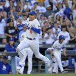Oct 13, 2024; Los Angeles, California, USA; Los Angeles Dodgers first base Freddie Freeman (5) runs towards home plate to score a run against the New York Mets during the first inning in game one of the NLCS for the 2024 MLB Playoffs at Dodger Stadium. Mandatory Credit: Jayne Kamin-Oncea-Imagn Images