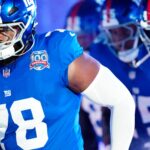 New York Giants offensive tackle Andrew Thomas (78) and his teammates run onto the field moments before kickoff, Sunday, October 13, 2024, in East Rutherford.