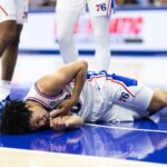 Oct 16, 2024; Philadelphia, Pennsylvania, USA; Philadelphia 76ers guard Jared McCain (20) reacts on the floor after being injured on a play against the Brooklyn Nets during the fourth quarter at Wells Fargo Center. Mandatory Credit: Bill Streicher-Imagn Images