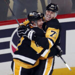 Oct 16, 2024; Pittsburgh, Pennsylvania, USA; Pittsburgh Penguins center Sidney Crosby (87) and center Evgeni Malkin (71) celebrate after Crosby scored the game winning power play goal in overtime to defeat the Buffalo Sabres at PPG Paints Arena. Mandatory Credit: Charles LeClaire-Imagn Images