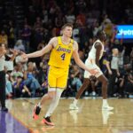 Oct 17, 2024; Phoenix, Arizona, USA; Los Angeles Lakers guard Dalton Knecht (4) reacts after making a three point basket against the Phoenix Suns during the overtime period at Footprint Center. Mandatory Credit: Joe Camporeale-Imagn Images