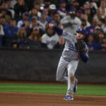 Oct 18, 2024; New York City, New York, USA; Los Angeles Dodgers third baseman Max Muncy (13) throws a ground ball to first base during the fifth inning against the New York Mets during game five of the NLCS for the 2024 MLB playoffs at Citi Field. Mandatory Credit: Vincent Carchietta-Imagn Images