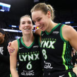 Oct 18, 2024; Minneapolis, Minnesota, USA; Minnesota Lynx forward Bridget Carleton (6) and forward Alanna Smith (8) celebrate their teams win after game four of the 2024 WNBA Finals against the New York Liberty at Target Center.