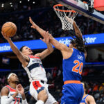 Oct 18, 2024; Washington, District of Columbia, USA; Washington Wizards guard Johnny Davis (1) takes a shot over New York Knicks center Jericho Sims (20) during the fourth quarter at Capital One Arena. Mandatory Credit: Reggie Hildred-Imagn Images
