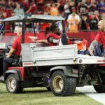 Oct 21, 2024; Tampa, Florida, USA; Tampa Bay Buccaneers wide receiver Chris Godwin (14) is carted off the field against the Baltimore Ravens in the fourth quarter at Raymond James Stadium. Mandatory Credit: Nathan Ray Seebeck-Imagn Images