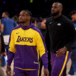Oct 22, 2024; Los Angeles, California, USA; Los Angeles Lakers guard Bronny James (9) and forward LeBron James (23) warm up before a game against the Minnesota Timberwolves at Crypto.com Arena.