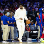 Oct 23, 2024; Philadelphia, Pennsylvania, USA; Philadelphia 76ers center Joel Embiid in plain clothes dribbles the ball during a timeout in the second quarter against the Milwaukee Bucks at Wells Fargo Center.
