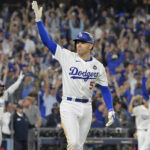 Oct 25, 2024; Los Angeles, California, USA; Los Angeles Dodgers first baseman Freddie Freeman (5) celebrates after hitting a grand slam home run in the tenth inning against the New York Yankees during game one of the 2024 MLB World Series at Dodger Stadium. Mandatory Credit: Jayne Kamin-Oncea-Imagn Images