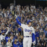 Oct 25, 2024; Los Angeles, California, USA; Los Angeles Dodgers first baseman Freddie Freeman (5) celebrates after hitting a grand slam home run in the tenth inning against the New York Yankees during game one of the 2024 MLB World Series at Dodger Stadium. Mandatory Credit: Jayne Kamin-Oncea-Imagn Images