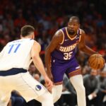 Oct 26, 2024; Phoenix, Arizona, USA; Phoenix Suns forward Kevin Durant (35) moves the ball against Dallas Mavericks guard Luka Doncic (77) in the first half of the home opener at Footprint Center.