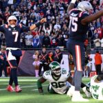 Oct 27, 2024; Foxborough, Massachusetts, USA; New England Patriots quarterback Jacoby Brissett (7) reacts after a touchdown against the New York Jets during the second half at Gillette Stadium. Mandatory Credit: Brian Fluharty-Imagn Images