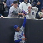 Oct 29, 2024; Bronx, New York, USA; Los Angeles Dodgers outfielder Mookie Betts (50) makes a catch in foul terriotory against the New York Yankees in the first inning during game four of the 2024 MLB World Series at Yankee Stadium. Mandatory Credit: Robert Deutsch-Imagn Images