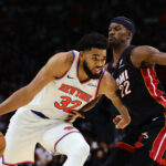 Oct 30, 2024; Miami, Florida, USA; New York Knicks center Karl-Anthony Towns (32) drives to the basketball against Miami Heat forward Jimmy Butler (22) during the fourth quarter at Kaseya Center.