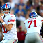 Aug 3, 2014; Canton, OH, USA; New York Giants quarterback Eli Manning (10) looks to throw a pass during the first quarter of the 2014 Pro Football Hall of Fame game against the Buffalo Bills at Fawcett Stadium. Mandatory Credit: Andrew Weber-USA TODAY Sports