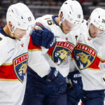 OTTAWA, ON - OCTOBER 10: Florida Panthers Center Aleksander Barkov (16) is helped off the ice by teammates Left Wing Evan Rodrigues (17) and Defenceman Uvis Balinskis (26) during third period National Hockey League action between the Florida Panthers and Ottawa Senators on October 10, 2024, at Canadian Tire Centre in Ottawa, ON, Canada