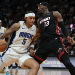 Feb 6, 2024; Miami, Florida, USA; Orlando Magic forward Paolo Banchero (5) drives to the basket as Miami Heat center Bam Adebayo (13) defends during the second half at Kaseya Center