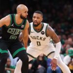 Nov 22, 2023; Boston, Massachusetts, USA; Milwaukee Bucks guard Damian Lillard (0) defends Boston Celtics guard Derrick White (9) during the second half at TD Garden.