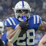 Sep 22, 2024; Indianapolis, Indiana, USA; Indianapolis Colts running back Jonathan Taylor (28) rushes for a touchdown during a game against the Chicago Bears at Lucas Oil Stadium.
