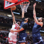 CHICAGO, IL - OCTOBER 12: Chicago Bulls forward Dalen Terry (25) shoots the ball over over Memphis Grizzlies forward Maozinha Pereira (25) and Memphis Grizzlies center Jay Huff (30) during the second half of a preseason game on October 12, 2024 at the United Center in Chicago, Illinois. (Photo by Melissa Tamez/Icon Sportswire via Getty Images)