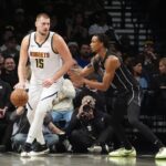 Oct 29, 2024; Brooklyn, New York, USA; Denver Nuggets center Nikola Jokic (15) dribbles the ball against Brooklyn Nets center Nic Claxton (33) during the second half at Barclays Center.