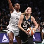 Oct 1, 2024; Brooklyn, New York, USA; New York Liberty guard Sabrina Ionescu (20) looks to drive past Las Vegas Aces guard Jackie Young (0) in the third quarter during game two of the 2024 WNBA Semi-finals at Barclays Center. Mandatory Credit: Wendell Cruz-Imagn Images