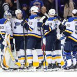 St. Louis Blues goalie Joel Hofer (30) celebrates a 5-2 win against the New York Rangers with his teammates at Madison Square Garden.