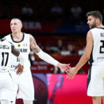 SHENZHEN, CHINA - SEPTEMBER 05: #17 Dennis Schroder, #10 Daniel Theis and #24 Maximilian Kleber of the Germany National Team react during the match against the Jordan National Team during the 1st round of 2019 FIBA World Cup at Shenzhen Bay Sports Center on September 05, 2019 in Shenzhen, China. (Photo by Zhong Zhi/Getty Images)