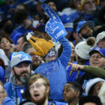 DETROIT, MI - NOVEMBER 25: A young Detroit fan wears a turkey-themed hat and holds up a large foam finger during a regular season Thanksgiving Day NFL football game between the Chicago Bears and the Detroit Lions on November 25, 2021 at Ford Field in Detroit, Michigan. (Photo by Scott W. Grau/Icon Sportswire via Getty Images)