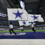 ARLINGTON, TX - NOVEMBER 10: The Dallas Cowboys flag crew runs through the end zone before the game between the Dallas Cowboys and the Philadelphia Eagles on November 10, 2024 at AT&T Stadium in Arlington, Texas. (Photo by Matthew Pearce/Icon Sportswire via Getty Images)
