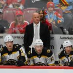 Boston Bruins head coach Jim Montgomery looks on from the bench against the Florida Panthers during the third period at Amerant Bank Arena.