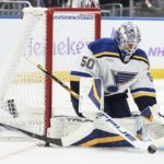 St. Louis Blues goaltender Jordan Binnington (50) makes a save on a shot on goal attempt in the second period against the New York Islanders at UBS Arena.