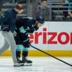Seattle Kraken forward JordanÊEberle (7) is helped from the ice by a trainer during the second period against the Chicago Blackhawks at Climate Pledge Arena.