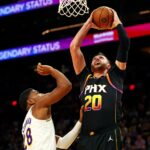 Phoenix Suns center Jusuf Nurkic (20) drives to the basket against Los Angeles Lakers forward Rui Hachimura (28) during the third quarter at Footprint Center.