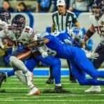 Chicago Bears quarterback Caleb Williams (18) is sacked by Detroit Lions defensive end Za'Darius Smith (99) in the fourth quarter on Thanksgiving Day at Ford Field in Detroit on Thursday, Nov. 28, 2024.