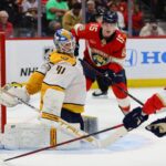 Nashville Predators goaltender Scott Wedgewood (41) defends his net as Florida Panthers center Evan Rodrigues (17) dives in an attempt to shoot the puck during the second period at Amerant Bank Arena.
