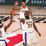 Sep 8, 2020; Lake Buena Vista, Florida, USA; Los Angeles Lakers forward LeBron James (23) celebrates with guard Rajon Rondo (9) and forward Kyle Kuzma (top) during the second half of game three in the second round of the 2020 NBA Playoffs at AdventHealth Arena.